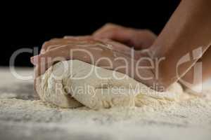 Woman kneading a dough