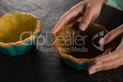 Woman holding tart dough on mold