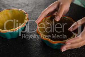 Woman holding tart dough on mold