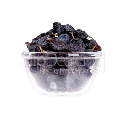 Saucer of prunes on white background, close up.