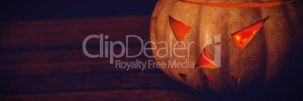 Close up of illuminated jack o lantern on table during Halloween