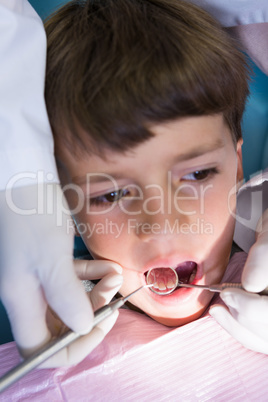 Boy looking away while receiving dental treatment at clinic