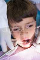 Boy looking away while receiving dental treatment at clinic