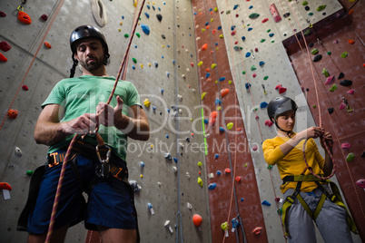 Low angle view of athletes tying rope in health club