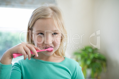 Girl brushing teeth in the bathroom