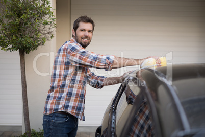 Man washing a car on a sunny day