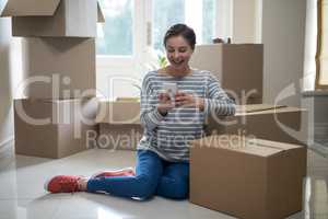 Woman using mobile phone while sitting