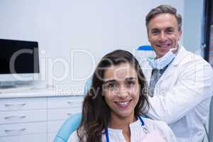 Portrait of patient sitting on chair by dentist