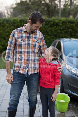 Young girl and father hugging each other