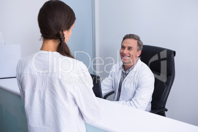 Happy dentist and woman talking in cabin