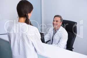 Happy dentist and woman talking in cabin