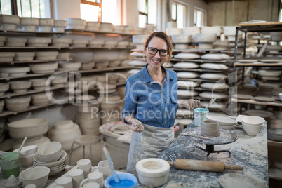 Portrait of female potter molding a clay