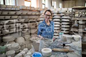 Portrait of female potter molding a clay
