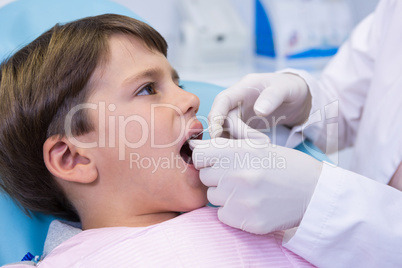 Boy receiving dental treatment by dentist