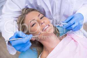 High angle portrait of woman by dentist dolding tool