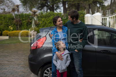 Father, mother and daughter standing near the car Father, mother and daughter standing near the car