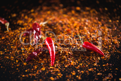 Red chilli flakes against black background