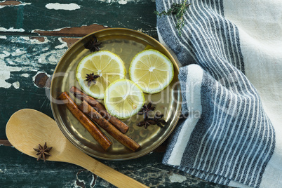 Various spices, spoon and napkin on wooden table