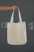 Cropped hand of female customer holding shoulder bag