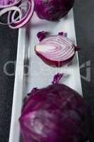 Close-up of onion with red cabbage in plate