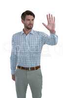 Man gesturing stop sign against white background