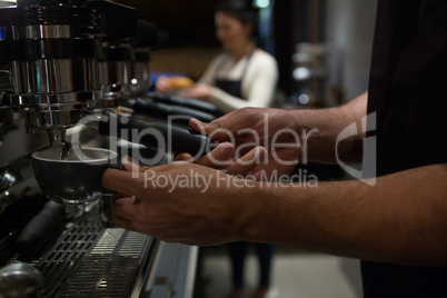 Mid section of waiter working at counter