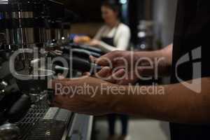 Mid section of waiter working at counter