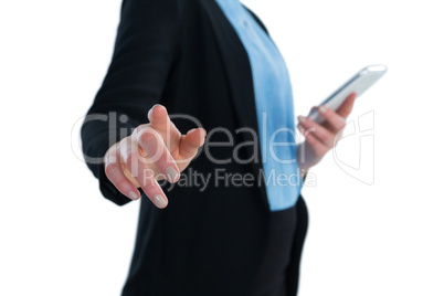 Mid section of businesswoman using mobile phone while using imaginary interface