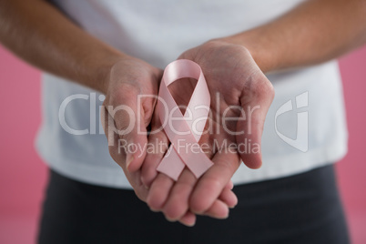 Close up of woman showing pink ribbon