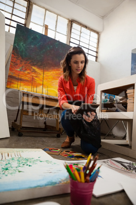 Woman using digital tablet in drawing class