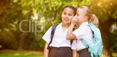 Composite image of girl whispering in friend ear
