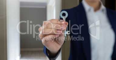 Hand holding key  in home