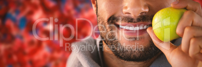 Composite image of close-up of smiling man holding apple