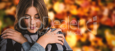 Composite image of close up of young woman covering with scarf