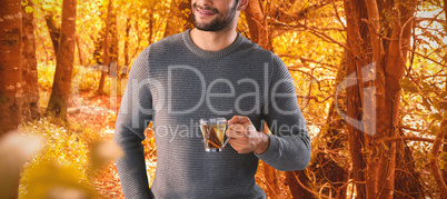 Composite image of smiling young man having lemon tea