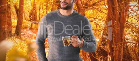Composite image of smiling young man having lemon tea