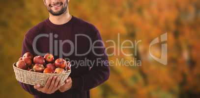 Composite image of portrait of man holding basket with apples