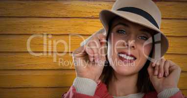 Woman against wood with hat