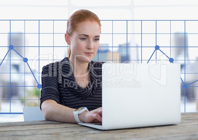 Businesswoman at desk with laptop and grid chart points