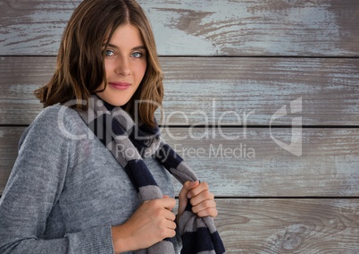 Woman against wood with warm scarf and jumper