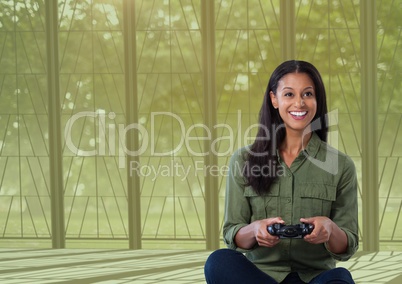 woman playing with computer game controller with nature background