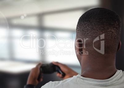man playing with computer game controller with bright blurred background