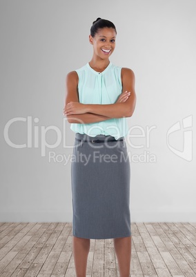 Businesswoman standing in room with arms folded