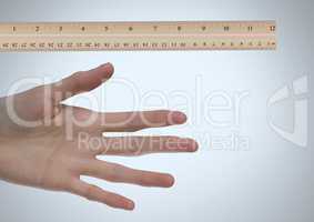 Ruler measuring size of long hand and fingers