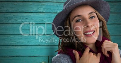 Woman against wood with scarf and hat