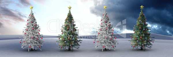 Christmas trees in winter landscape with dark cloudy sky