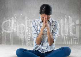 Woman praying meditating in front of city drawings