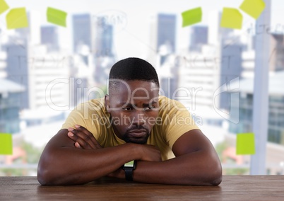 Businessman disappointed at desk with bright office window city background
