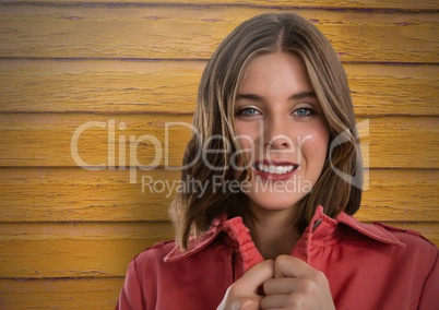Woman against wood with jumper closed tight and warm
