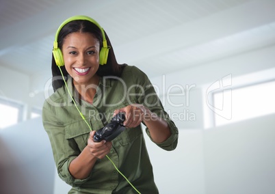 woman playing with computer game controller with bright background